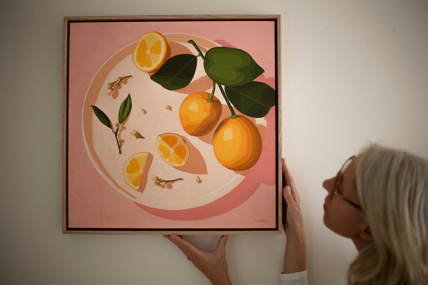 fine art print of a colorful and modern original oil painting of bright yellow lemons on a warm pink background with strong shadows