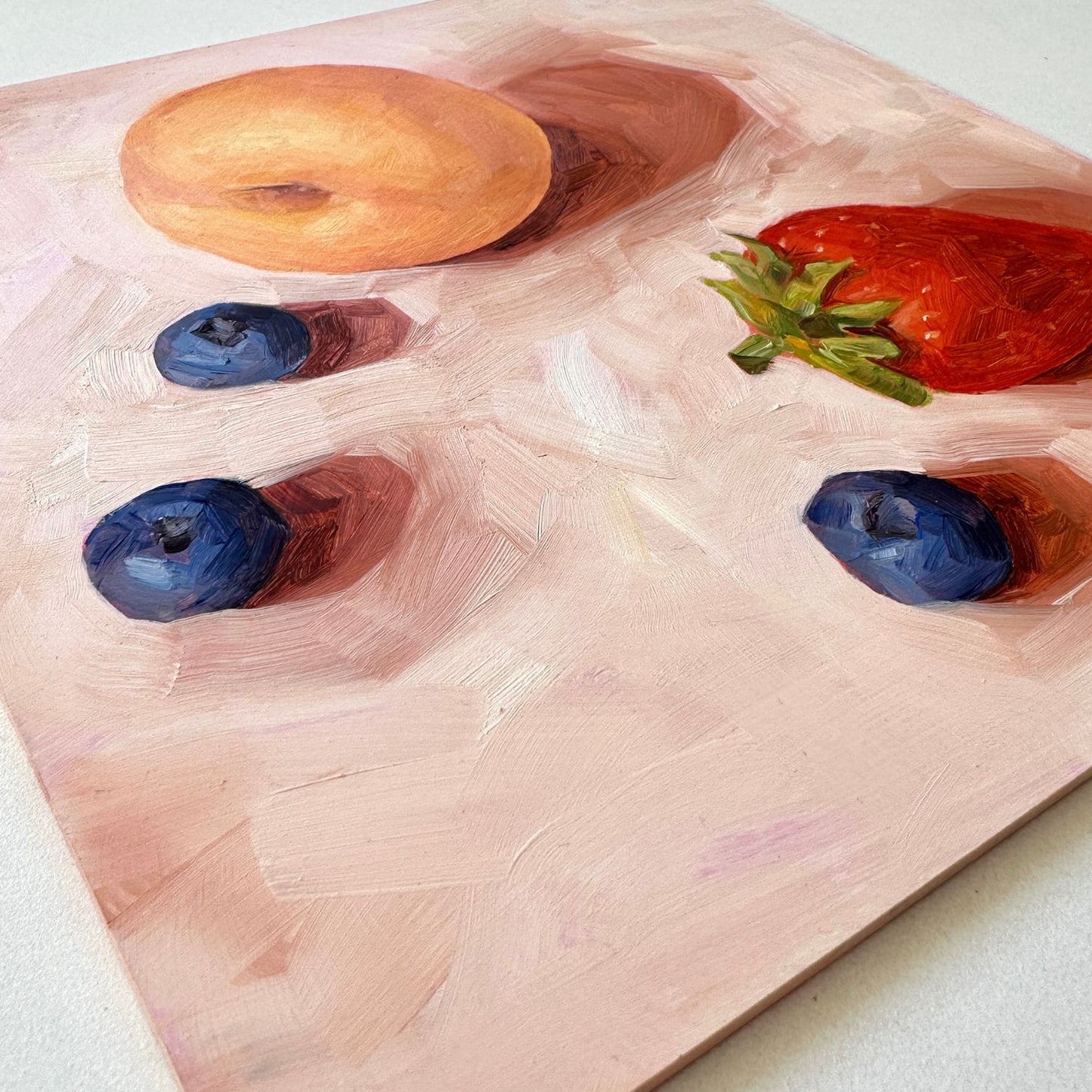 contemporary and modern original oil painting of fruits such as apricot, strawberry and blueberries on a textured creamy colored background