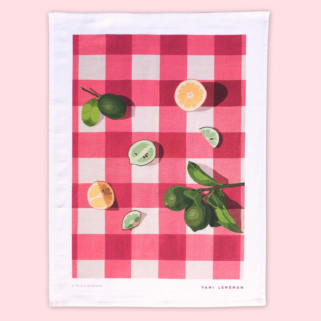 art tea towel of gingham checkered background in pink with lemons and limes