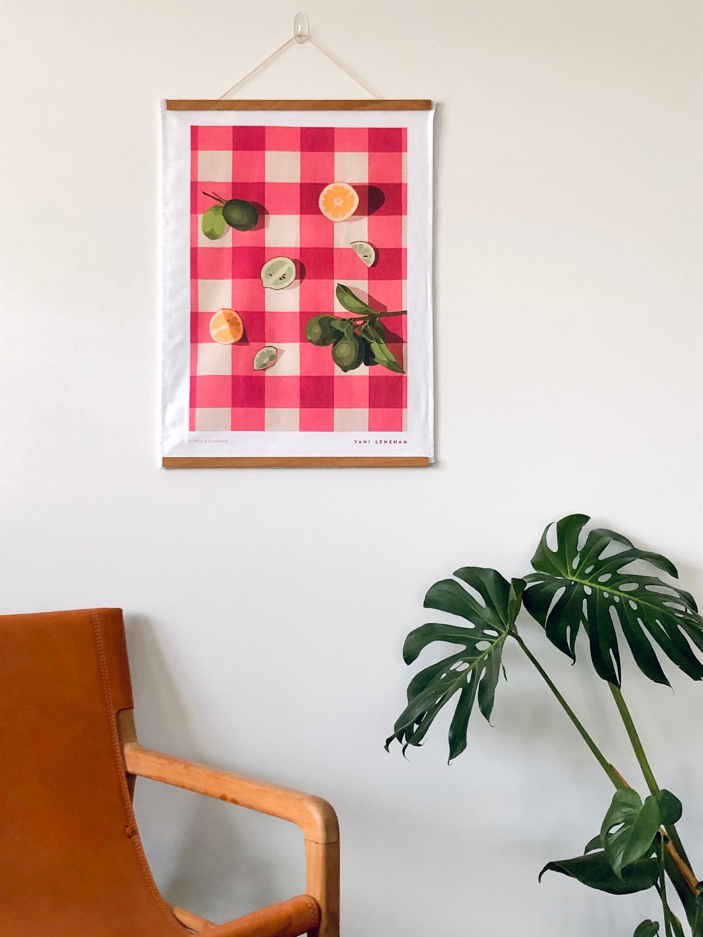 art tea towel of gingham checkered background in pink with lemons and limes