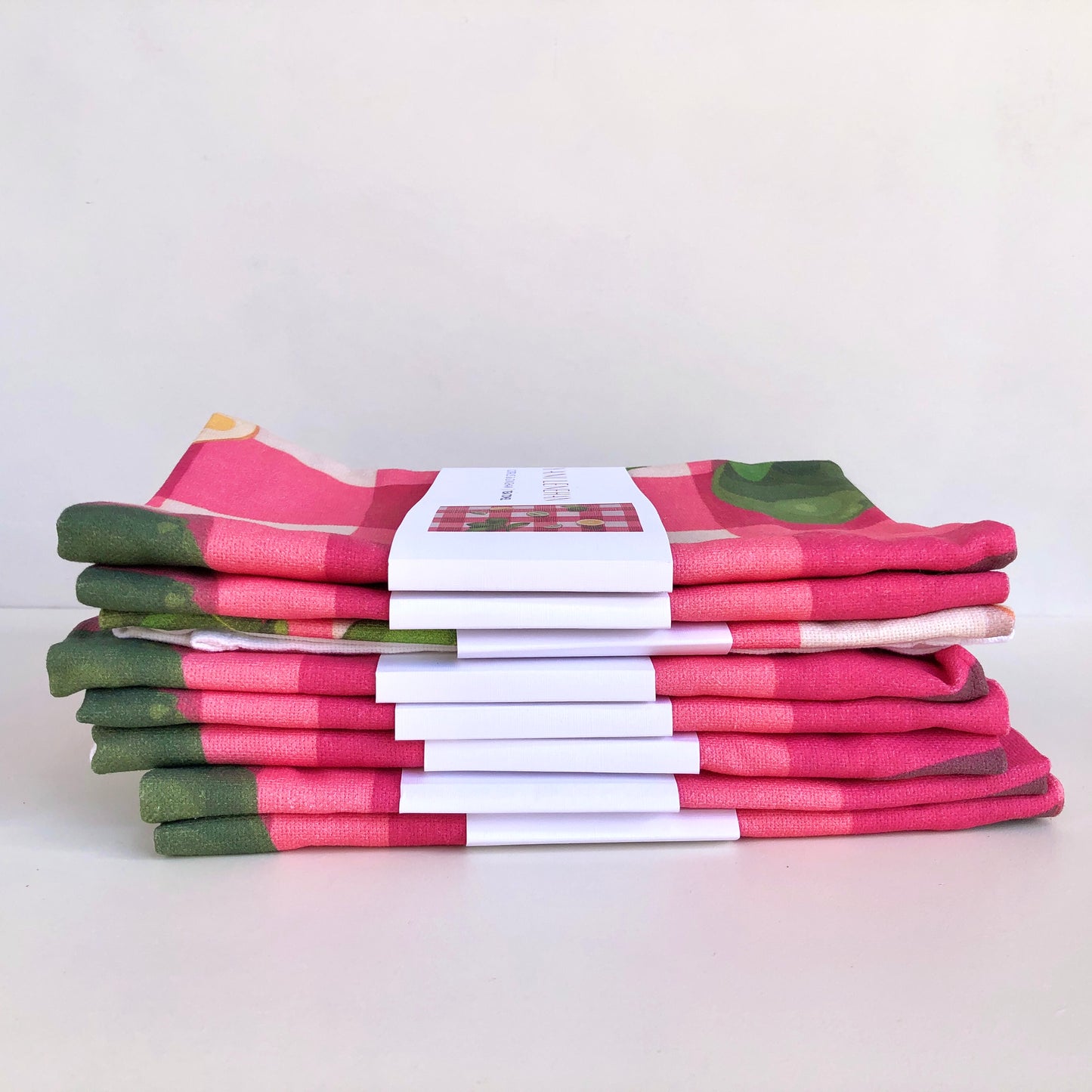 art tea towel of gingham checkered background in pink with lemons and limes