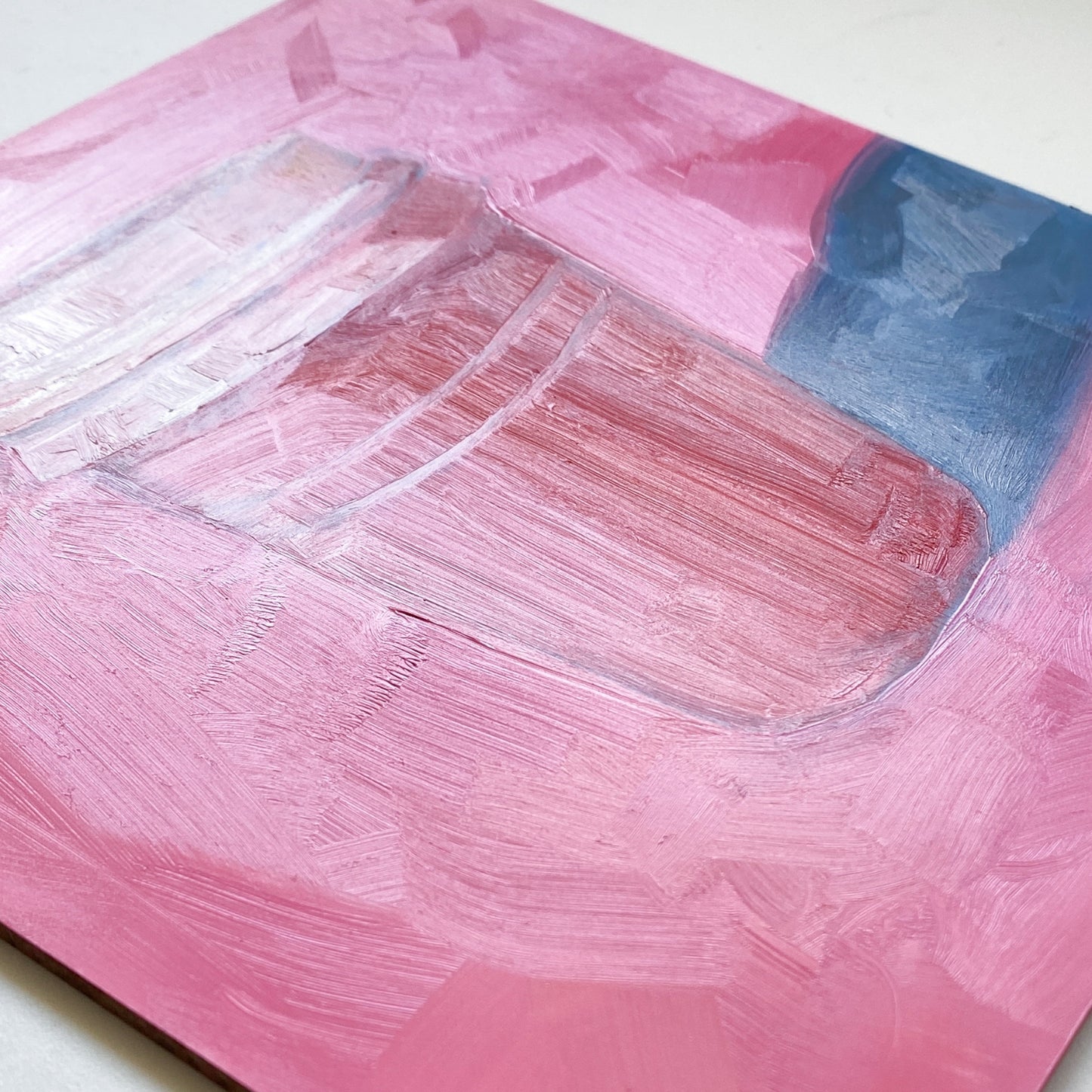 closeup of an original oil painting of a pink and red take away coffee cup on a textured bright pink background with strong greyish blue shadows.