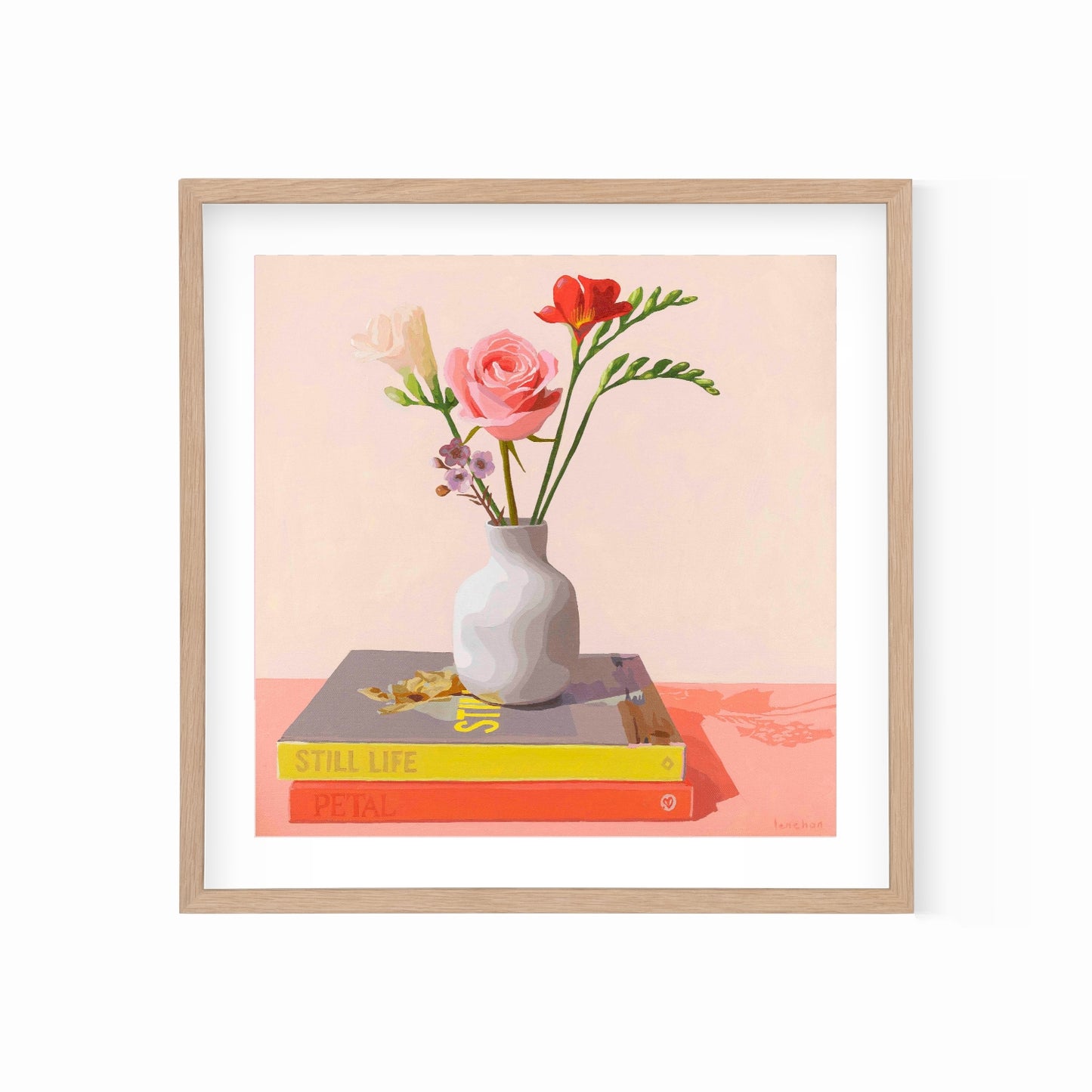 Framed artwork of a still life with flowers in a vase on books against a light peachy background.