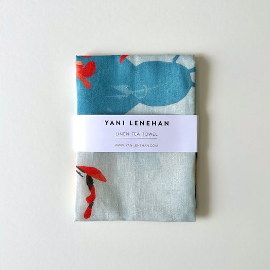 100 percent colourful linen tea towel of lemons on a light blue background