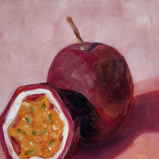 closeup of an original painting of a burgundy, magenta whole passionfruit and half a passionfruit with seeds. They are sitting on a soft pink surface and there are strong shadows and a diagonal background
