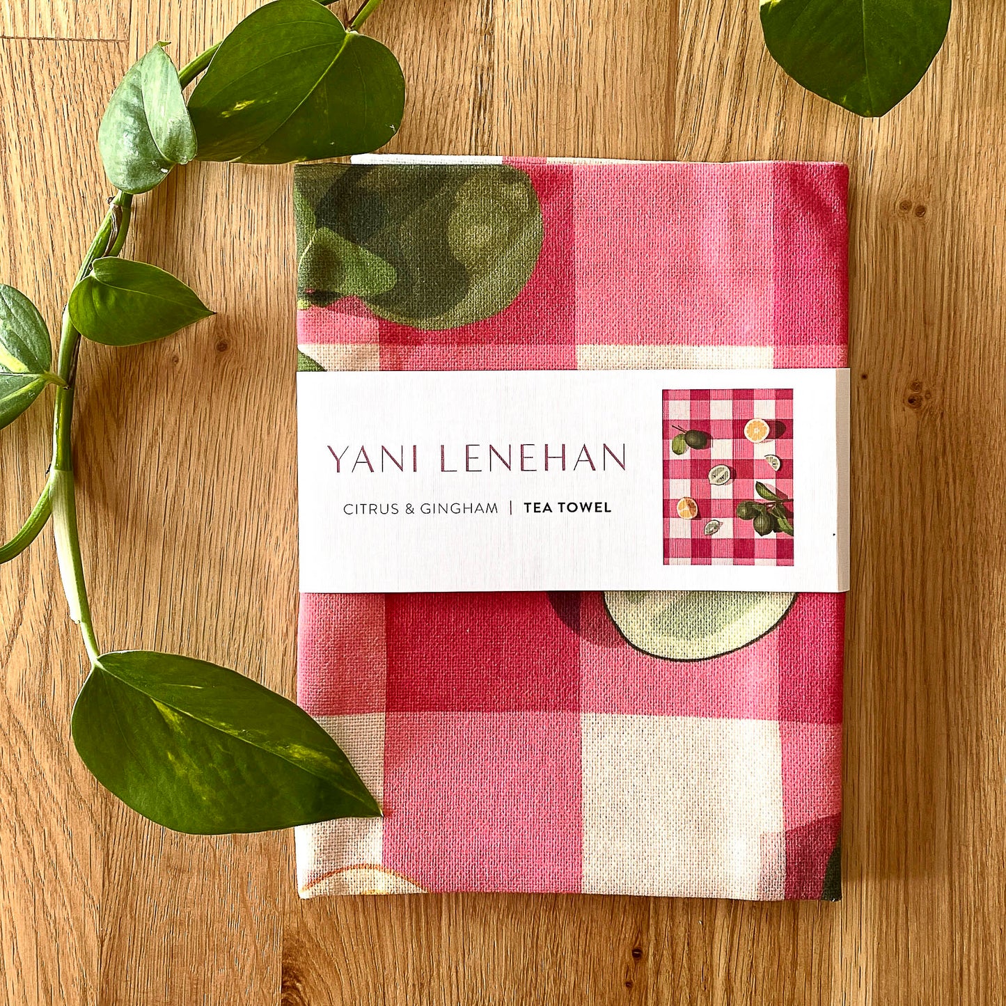 art tea towel of gingham checkered background in pink with lemons and limes