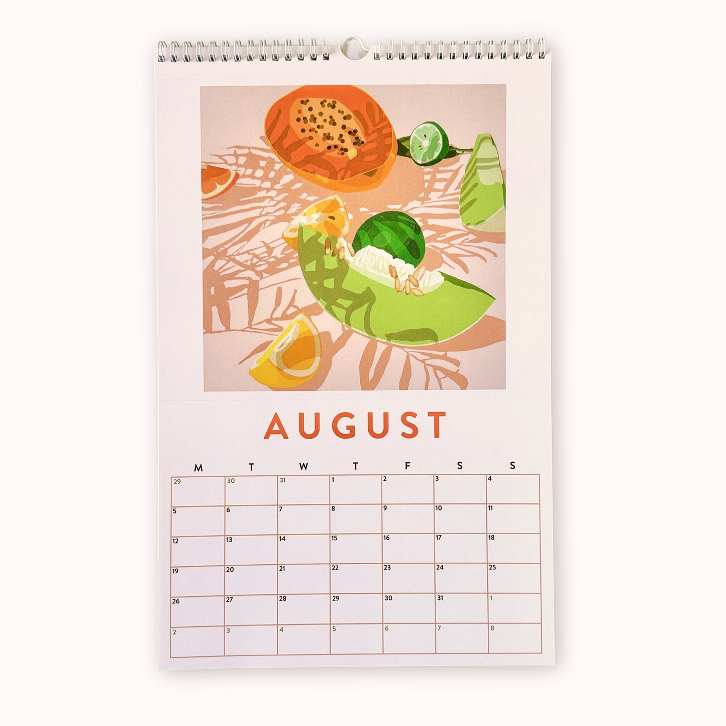 2024 art wall calendar in A3 size for the month of August, featuring a still life oil painting of fruits such as an orange papaya, a green rock melon, yellow lemon slices and limes on a creamy background with strong leaves shadows