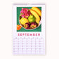 2024 art wall calendar in A3 size for the month of September, featuring a still life oil painting of a bowl of fruits such as yellow bananas, lemon, mangosteen, green pear, pink dragonfruit and an slice of orange on a green teal background