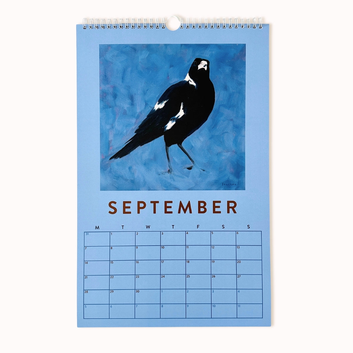 Calendar for September with a bird illustration on a blue background
