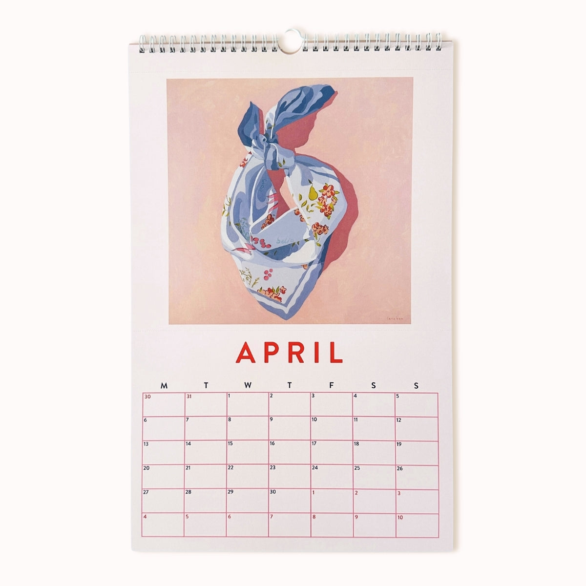 Calendar page for April with a floral scarf design on a pink background