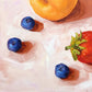 contemporary and modern original oil painting of fruits such as apricot, strawberry and blueberries on a textured creamy colored background