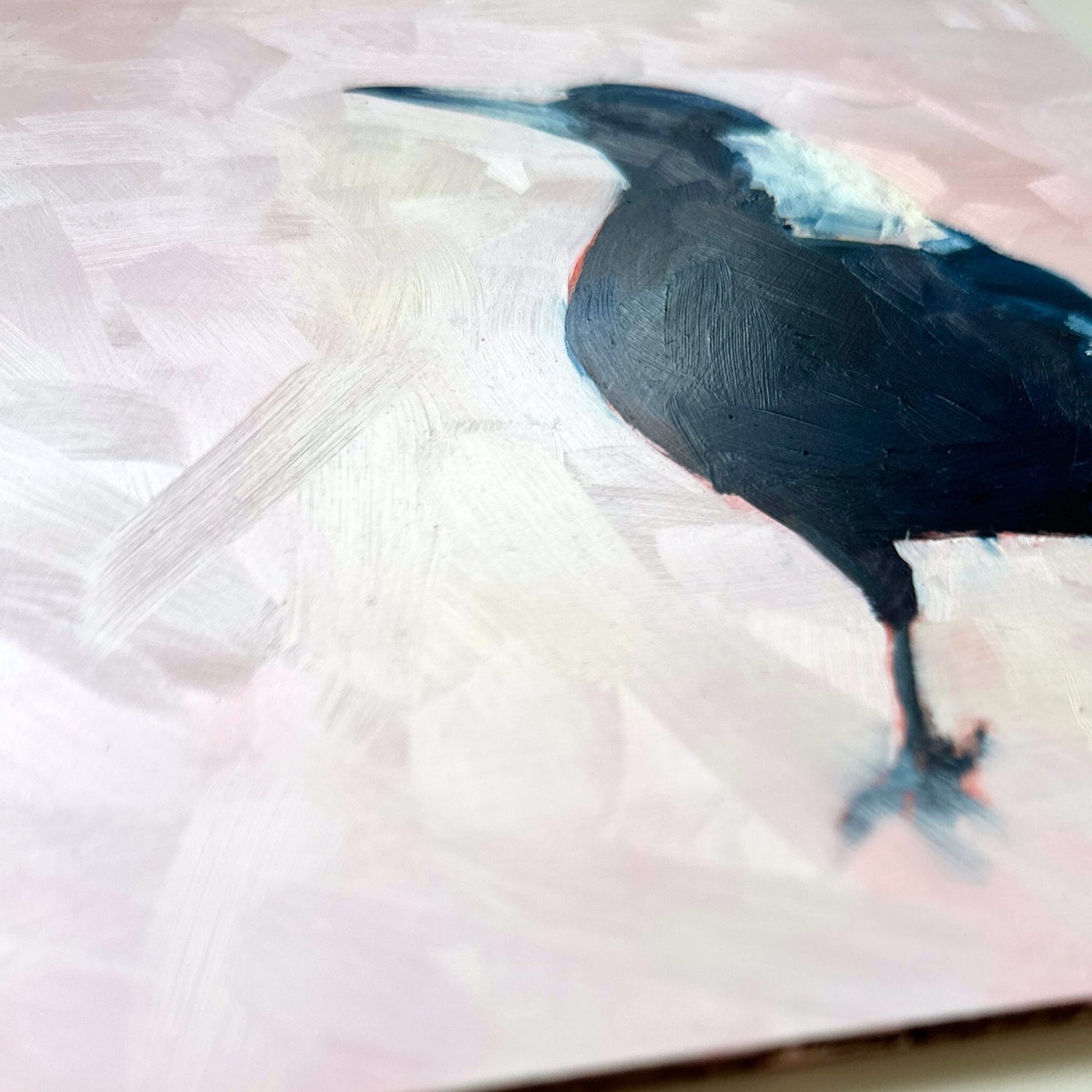 contemporary and modern oil painting of a navy blue and white baby magpie on a textured soft pink background