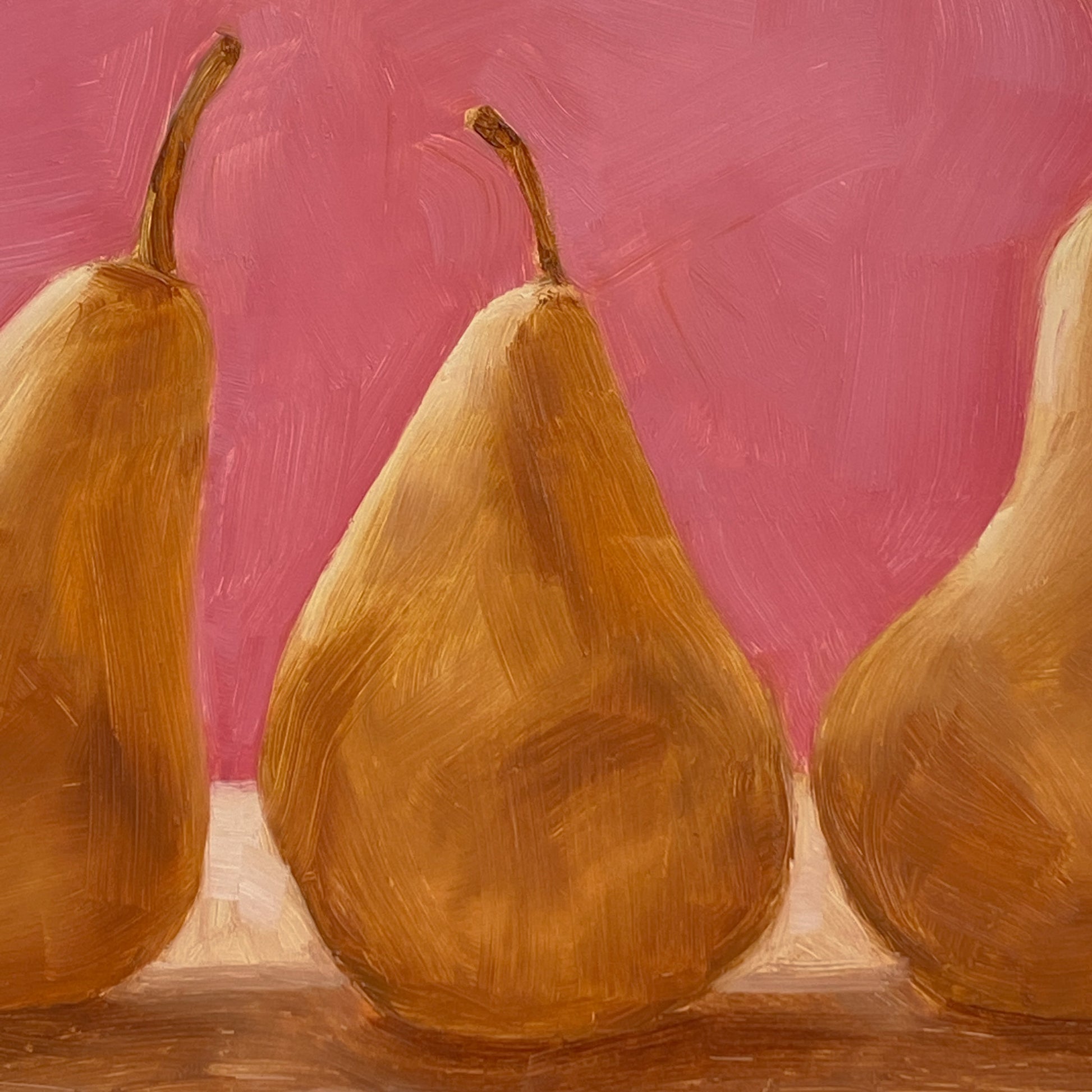closeup of an original oil paintings of three beurre Bosc pears on a warm pink and creamy background