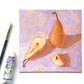 lifestyle photo of an original oil painting of three deep yellow orange beurre Bosc pears on a textured lilac background. the painting is on a white desk and there is a paintbrush and oil paint tube next to it