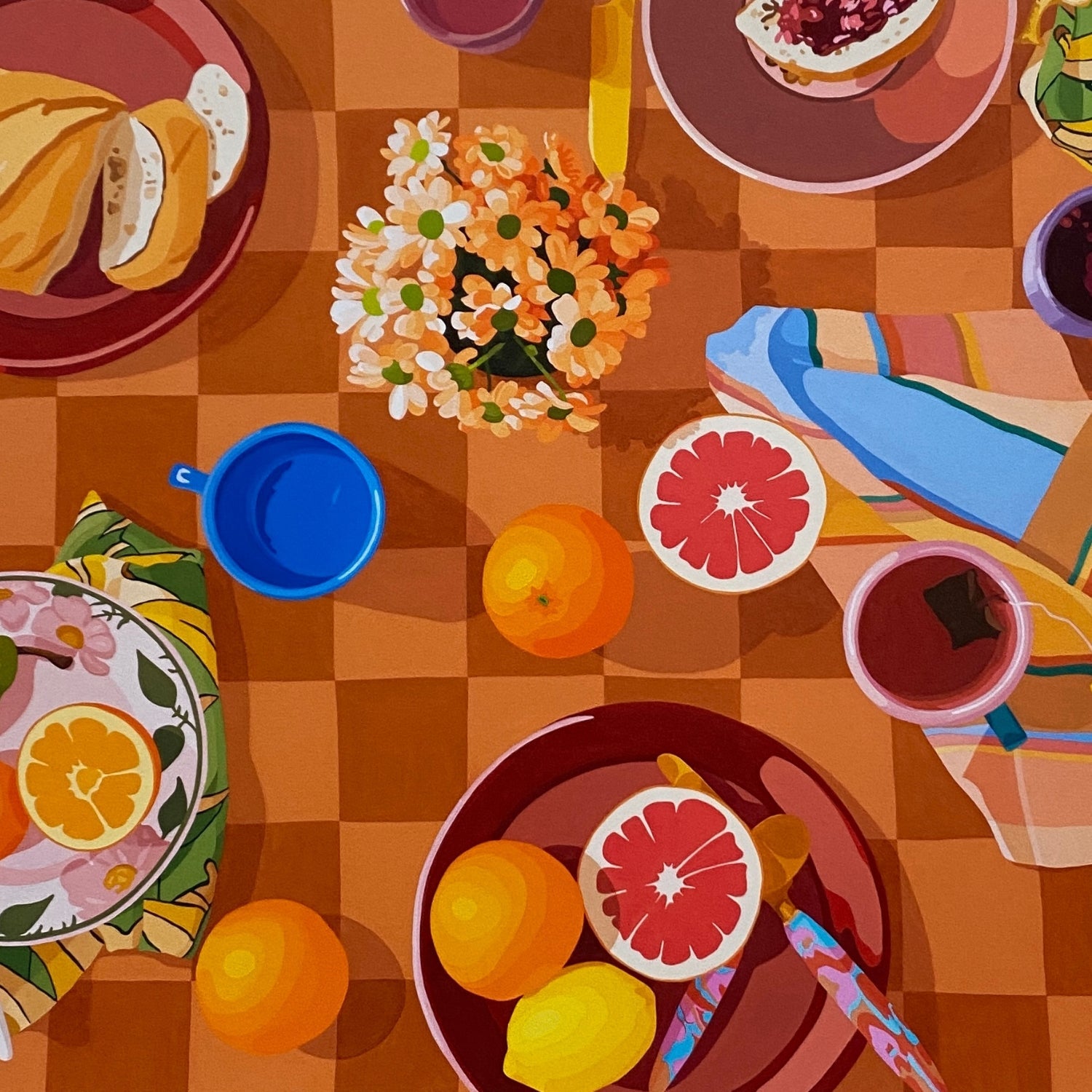 closeup photo of a print of a breakfast setup with oranges, lemons, tea towels, cutlery by kip and co, and flowers and cups on a chequered tablecloth background