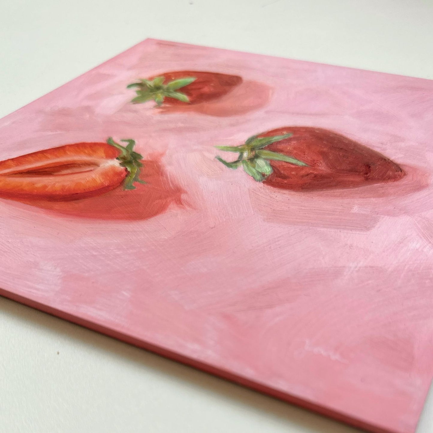 modern and contemporary original oil painting of bright red strawberries on a textured pink background