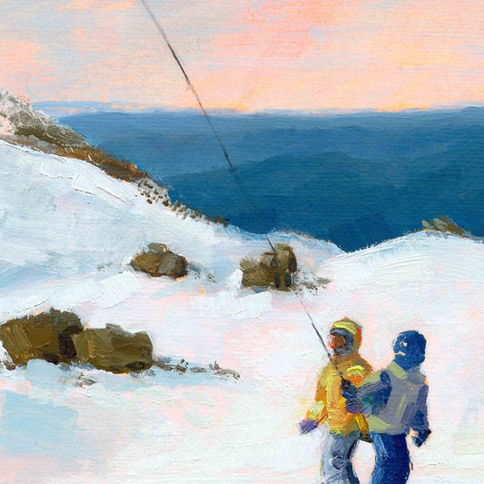 Two people with skis on a snowy landscape with a body of water and sunset sky.
