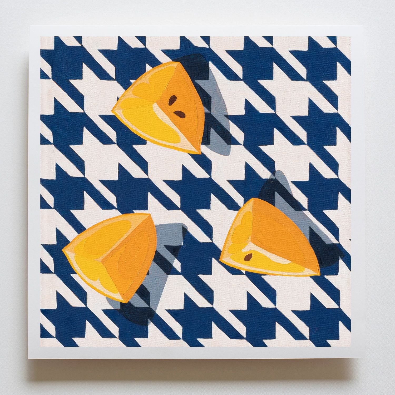 fine art print of a colorful and modern original oil painting of bright yellow lemons on a houndstooth navy blue and white background with strong shadows