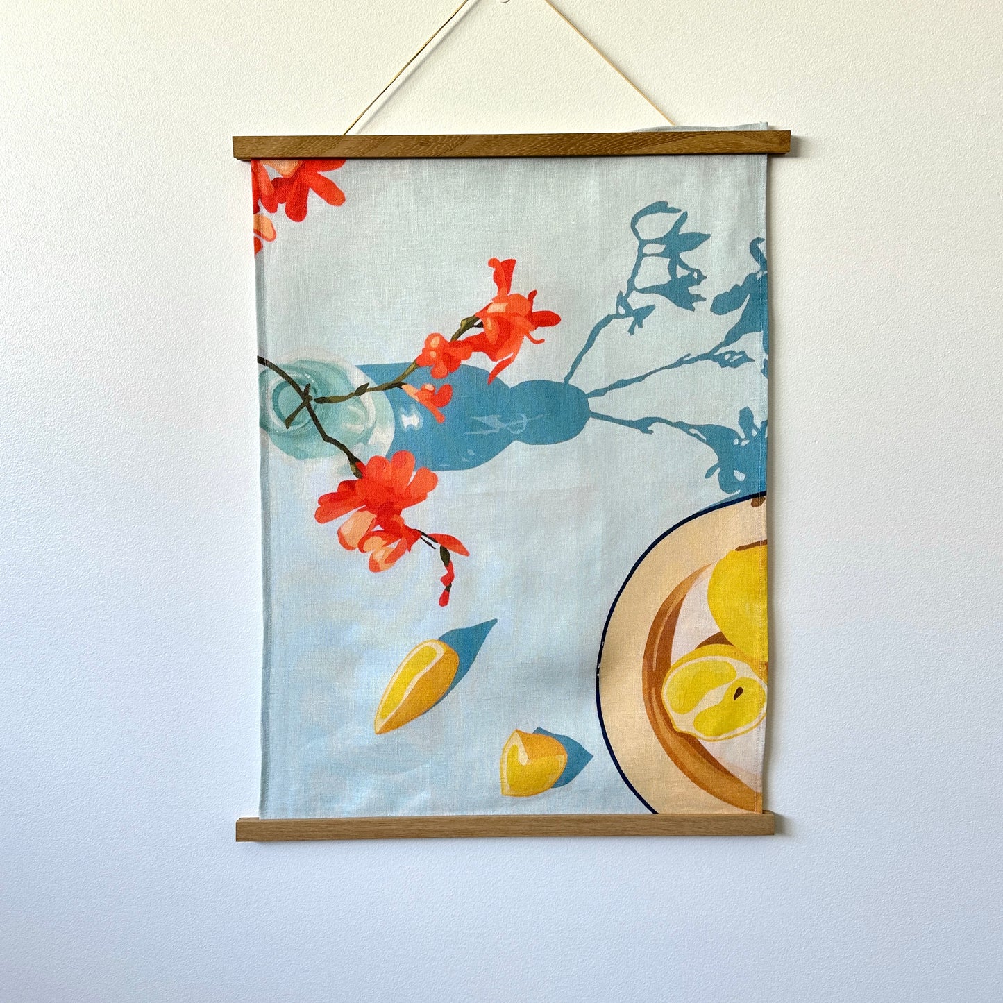 100 percent colourful linen tea towel of lemons on a light blue background
