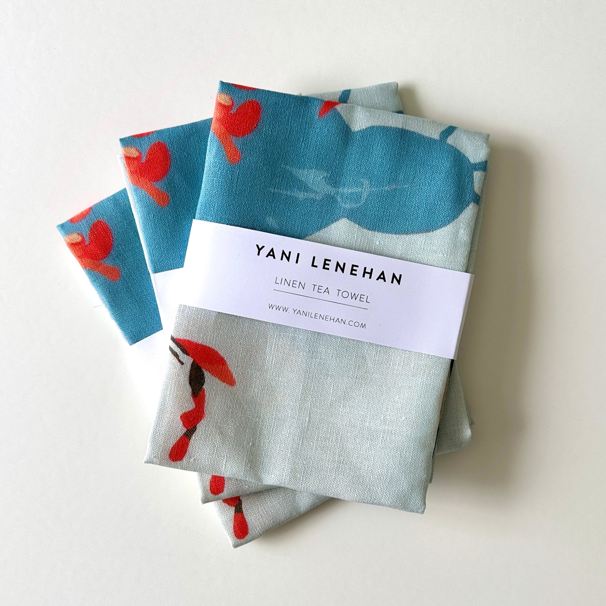100 percent colourful linen tea towel of lemons on a light blue background