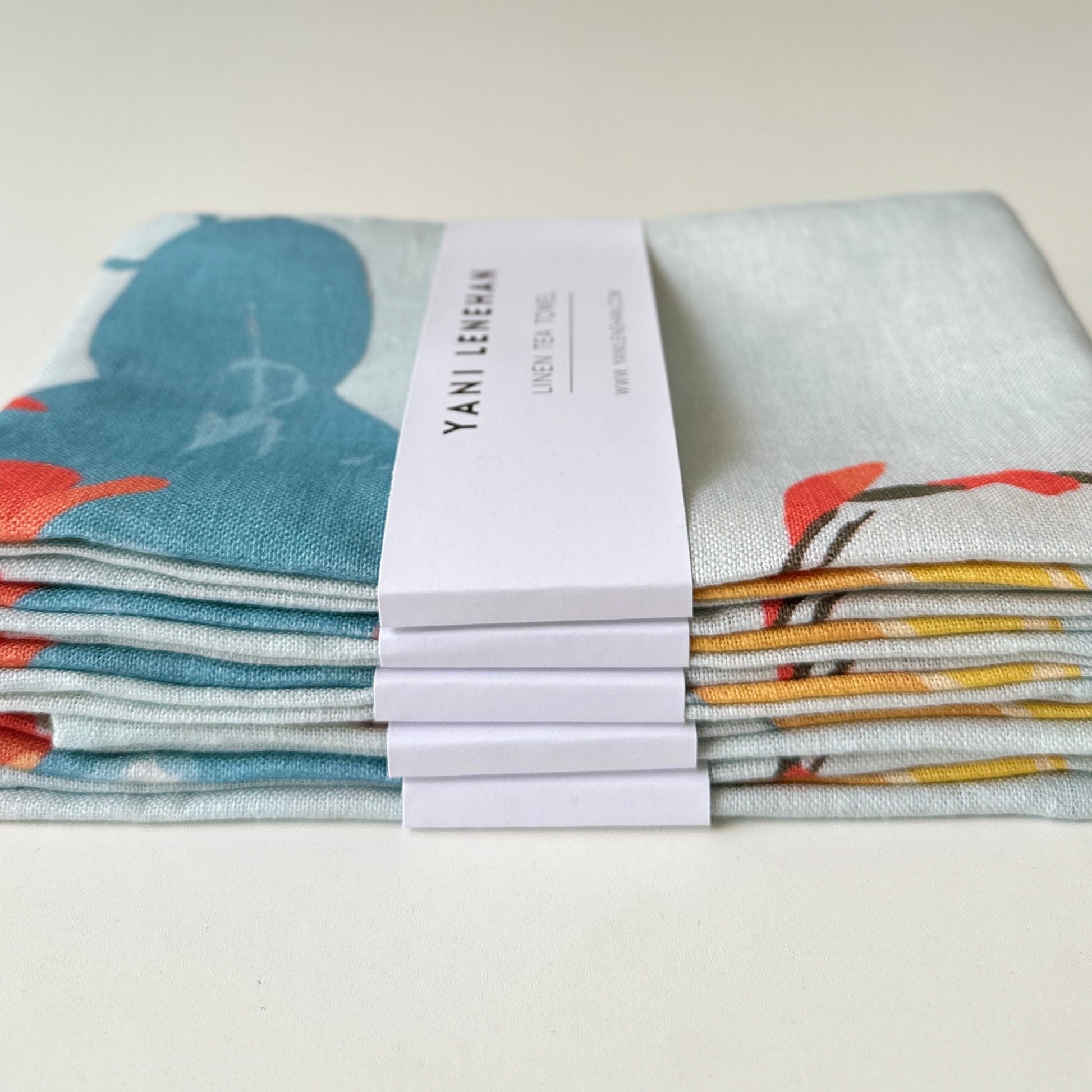 100 percent colourful linen tea towel of lemons on a light blue background