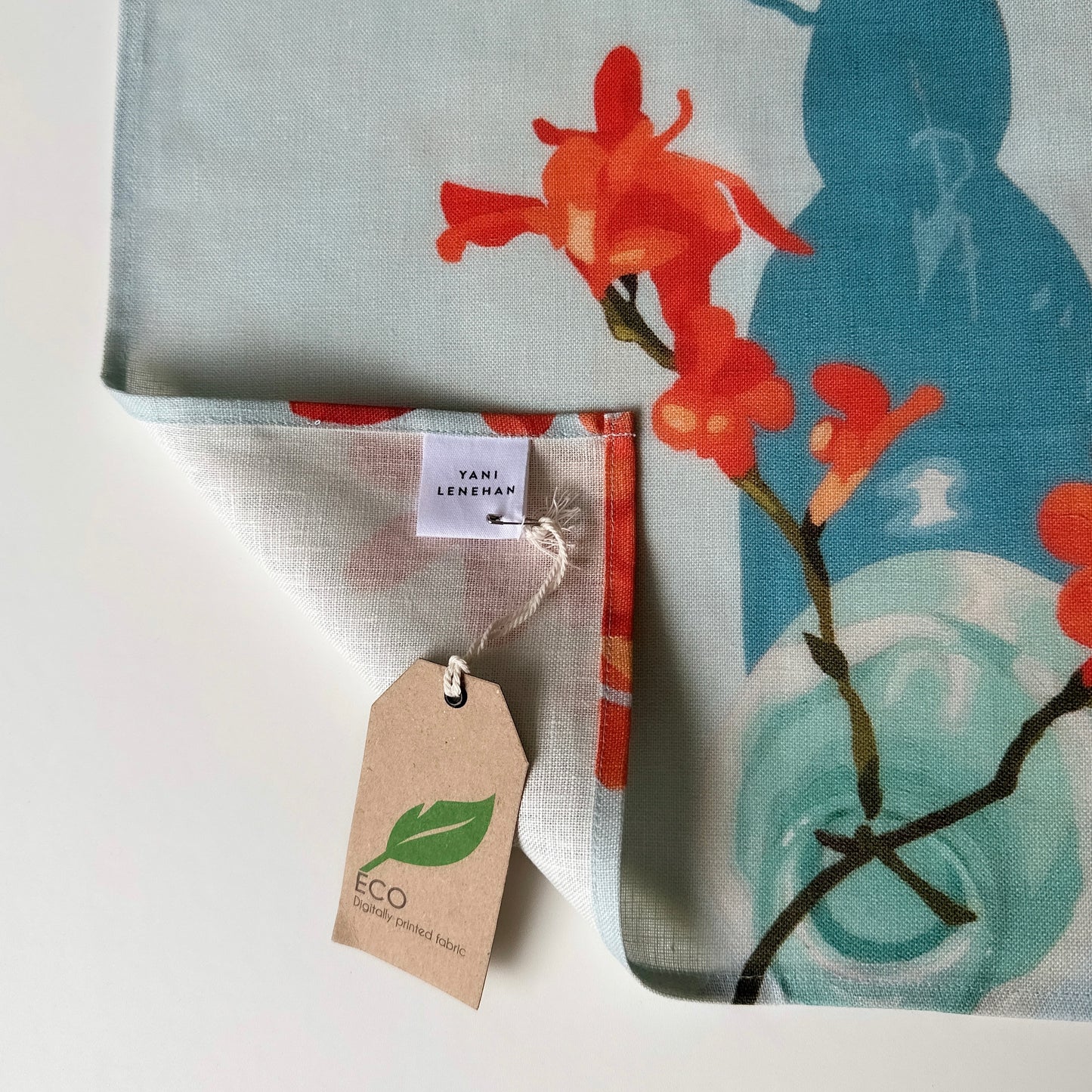 100 percent colourful linen tea towel of lemons on a light blue background