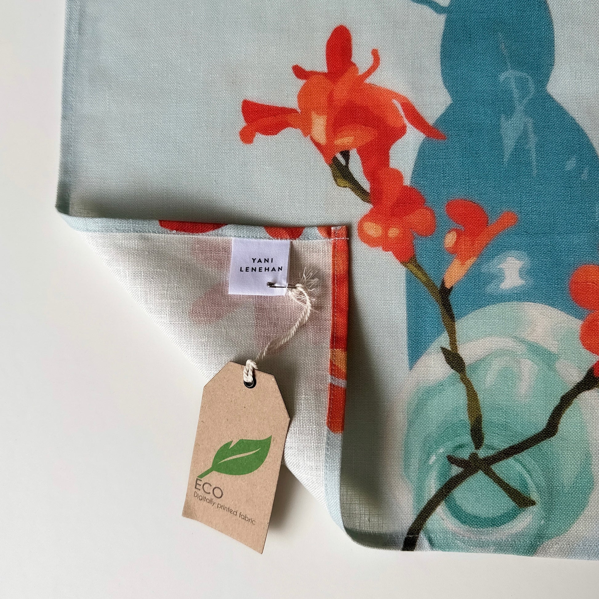 100 percent colourful linen tea towel of lemons on a light blue background