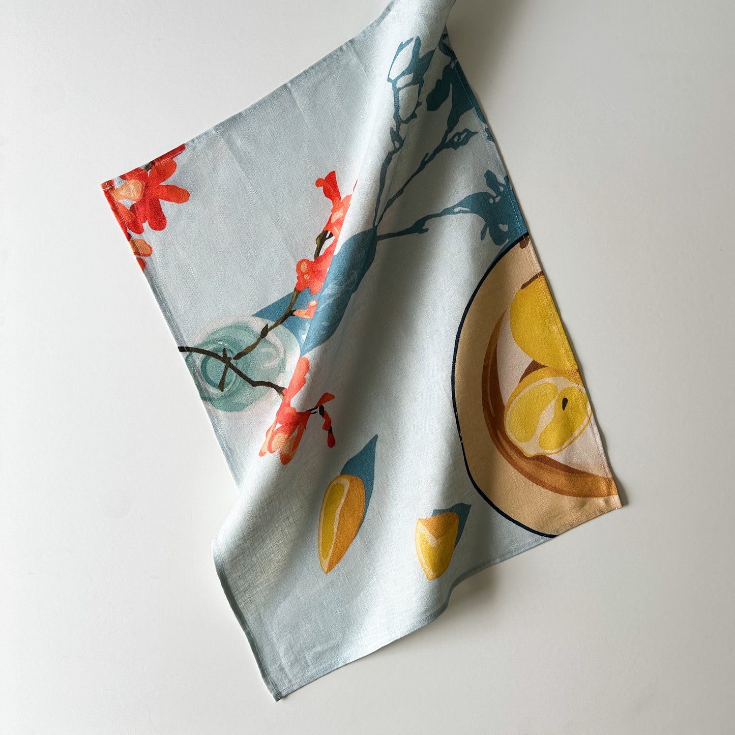 100 percent colourful linen tea towel of lemons on a light blue background