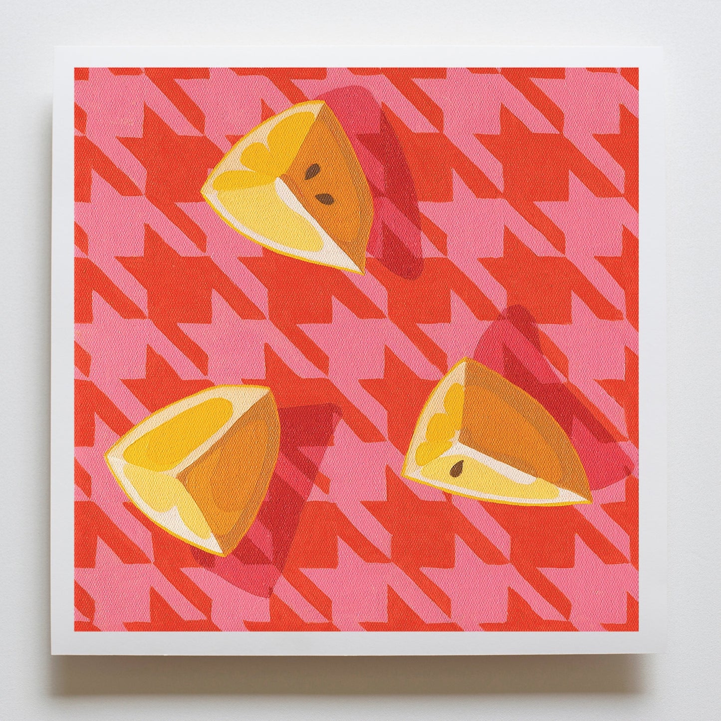 fine art paper print of an original oil painting of three wedges of lemon on a pink and red houndstooth background 