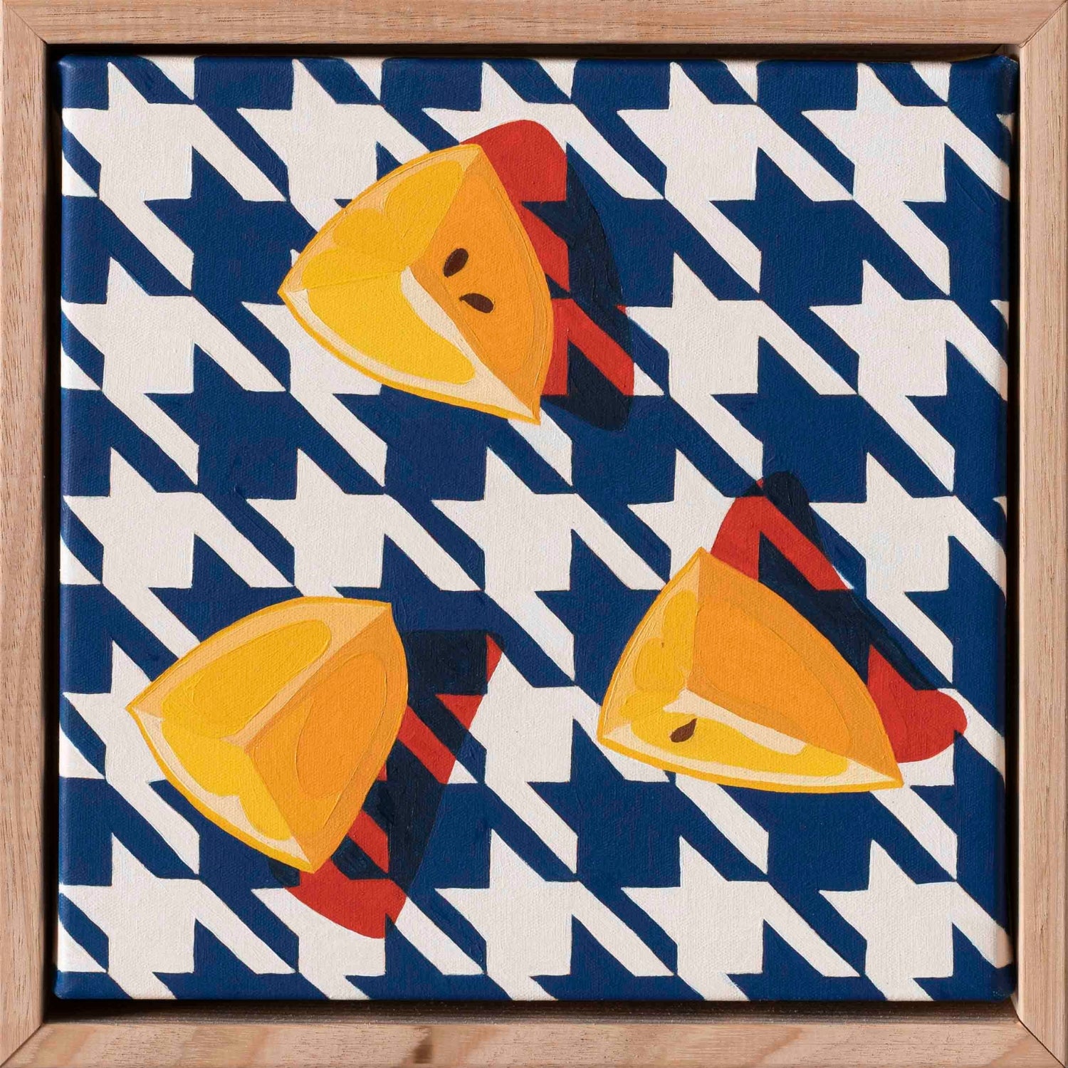 an original oil painting of three wedges of yellow lemons on a navy blue and white houndstooth background with strong red shadows framed in a wood timber shadow box