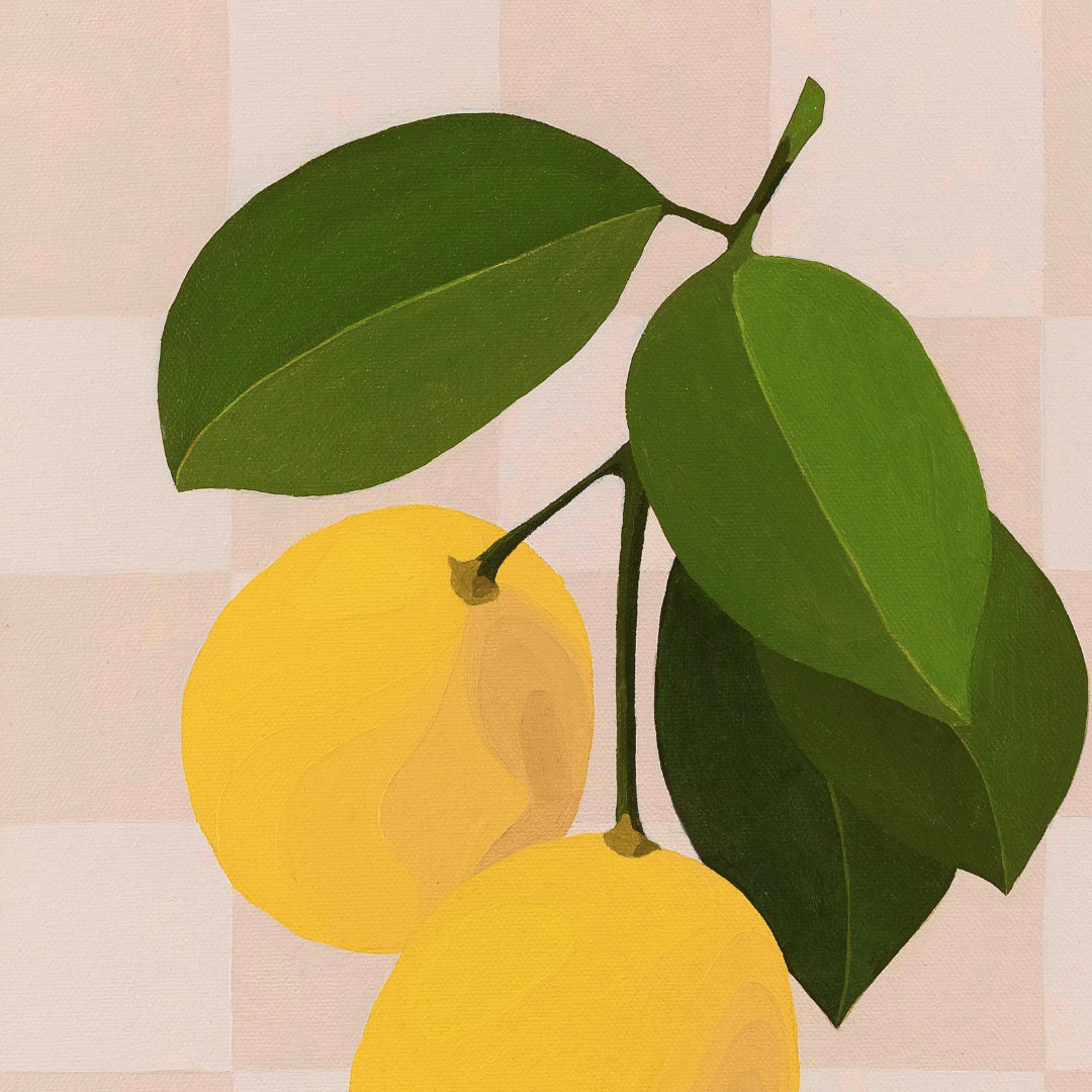 Two yellow lemons with green leaves on a striped background