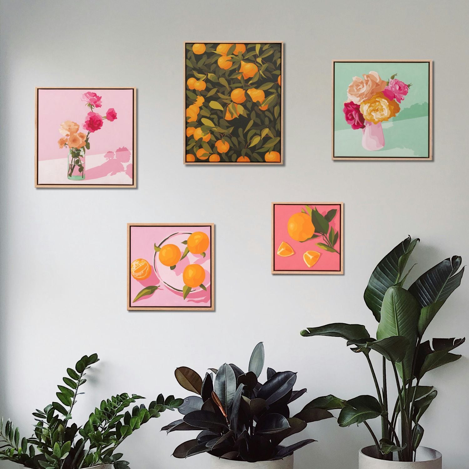 Lifestyle photo of original oil paintings hanging on a white wall surrounded by plants