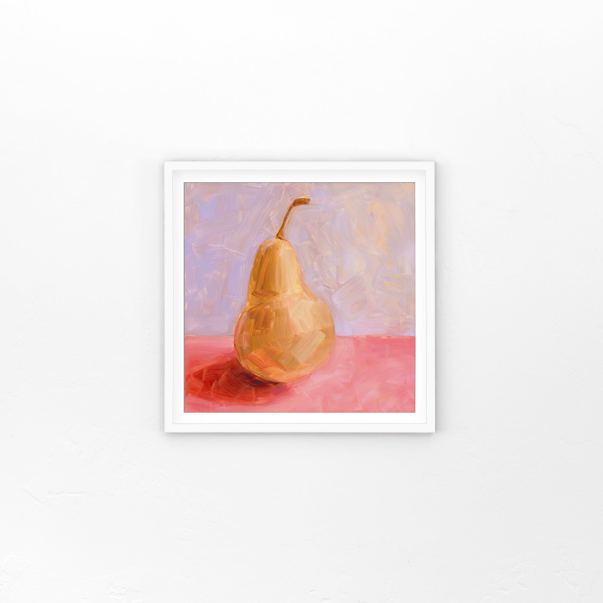 lifestyle photo of a fine art framed paper print of a yellow pear with strong red-pink shadows on a textured pink surface and a textured lilac background