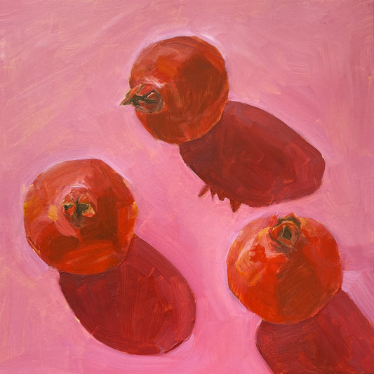 an image of an original oil painting on wooden panel of three red pomegranates on a bright pink background