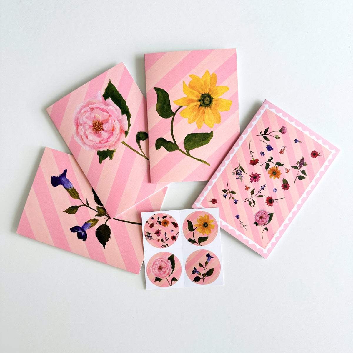 set of 4 greeting cards with pink and peachy stripes, pink scallops and a hand painted flowers. set comes with 4 matching stickers. blank inside