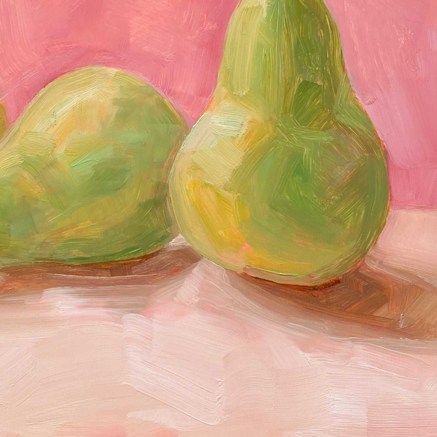 closeup of an image of an oil painting of two green pears and one yellow pear on a cream surface with a soft and warm pink background