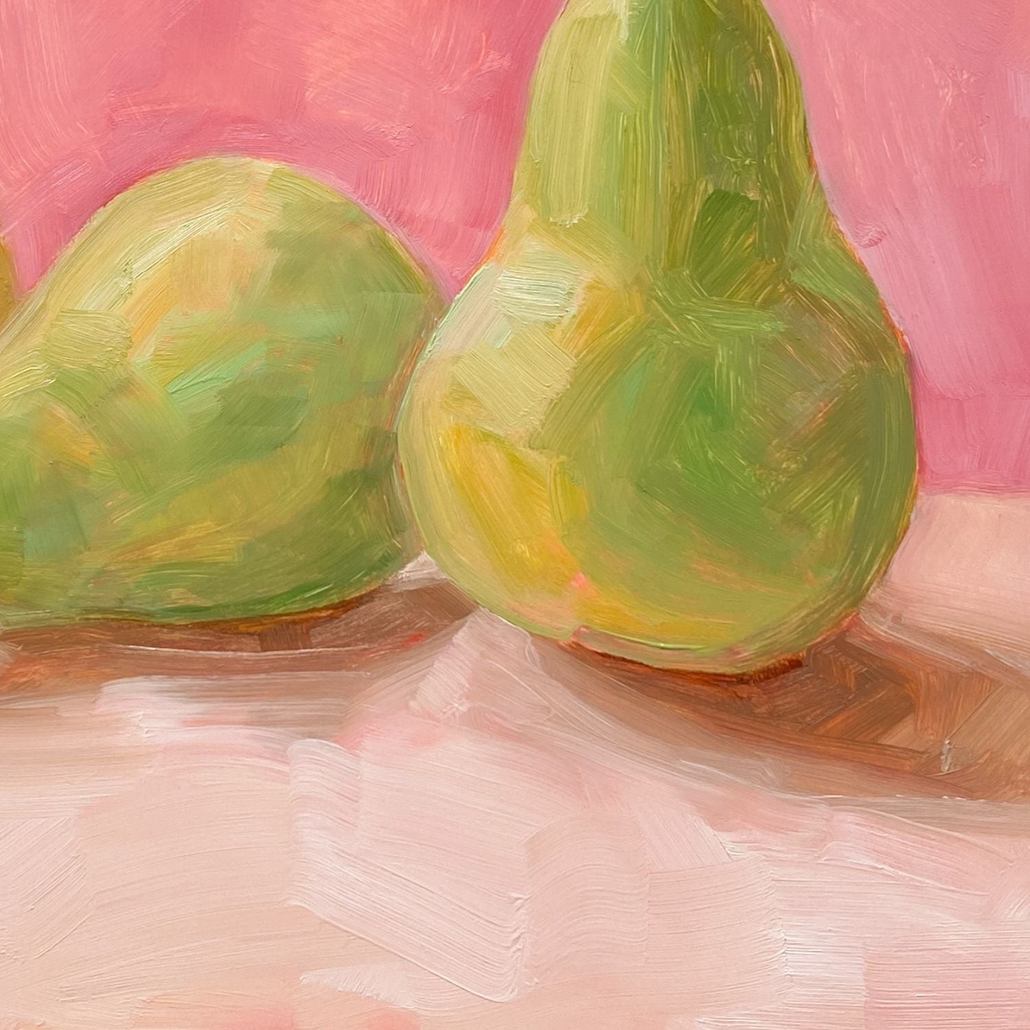 closeup of an image of an oil painting of two green pears and one yellow pear on a cream surface with a soft and warm pink background