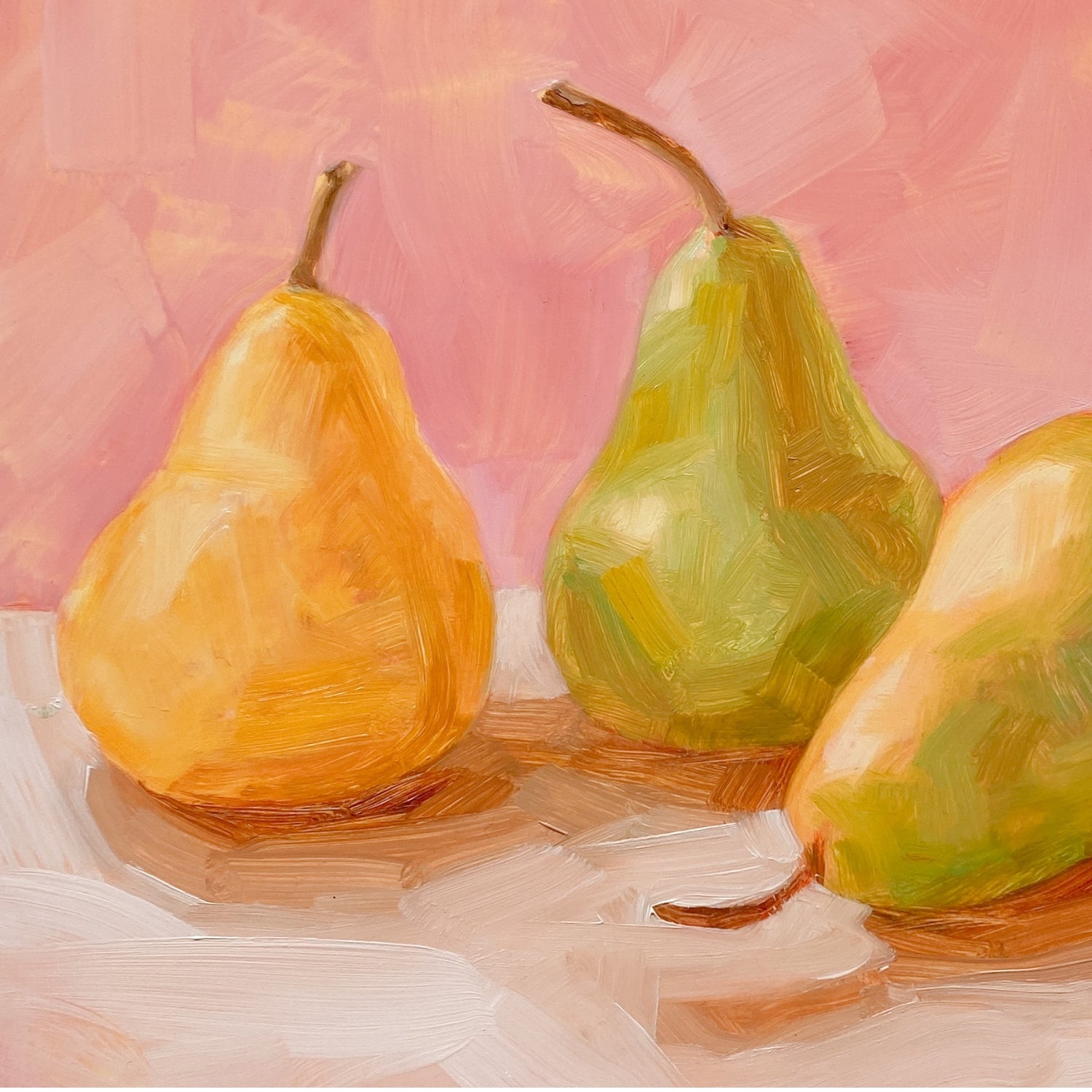 closeup of an original oil painting of three yellow and green pears on a soft cream surface and a soft pink background painted in an impressionistic way