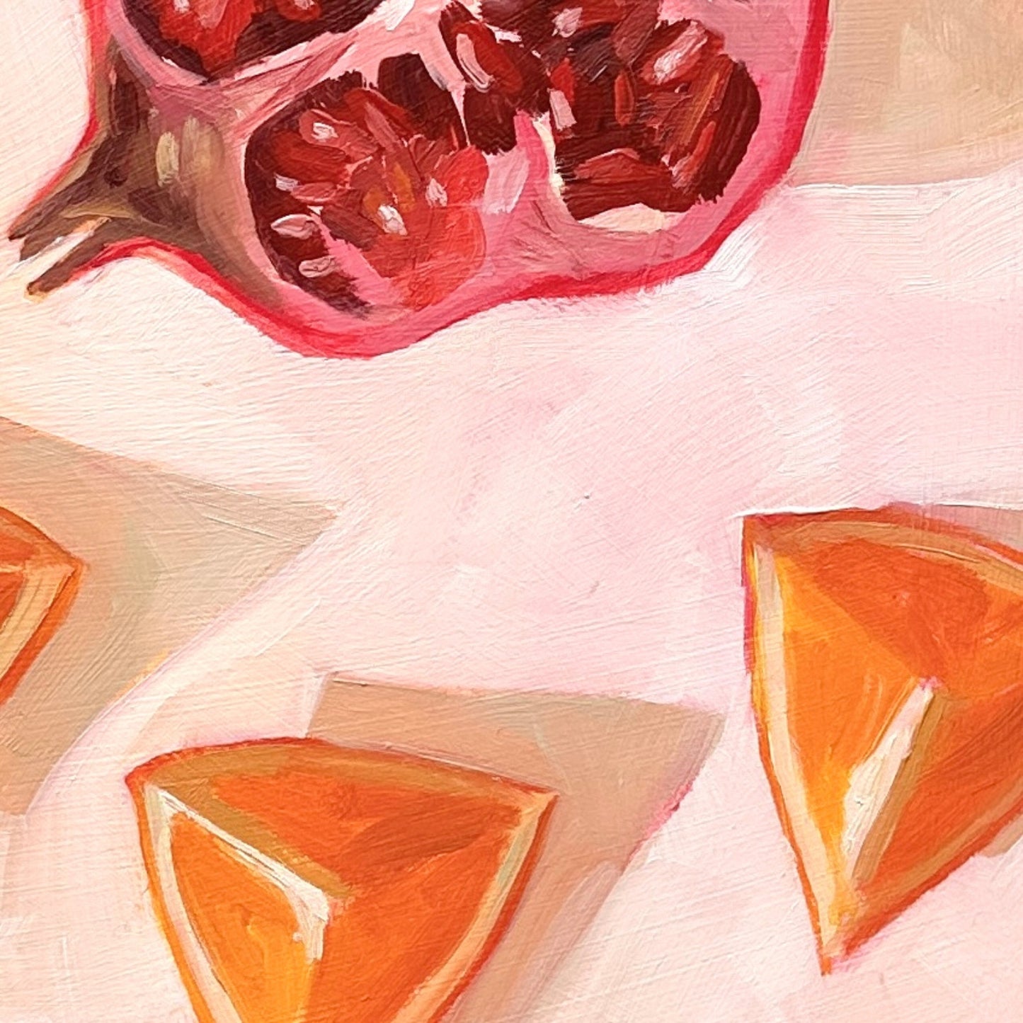 closeup of an impressionistic original oil painting of a still life setting of pomegranate fruit and three orange slices on a textured cream background with soft shadows