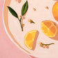 fine art print of a colorful and modern original oil painting of bright yellow lemons on a warm pink background with strong shadows