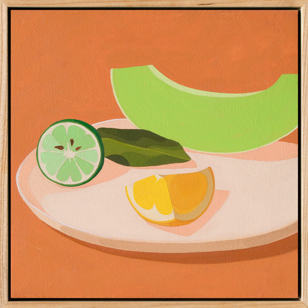 original oil painting of a slice of honeydew melon, a wedge of lemon and half a lime with leaves on a cream coloured plate, with very light warm pink shadows, sitting on chai coloured background, framed in American ash shadow box